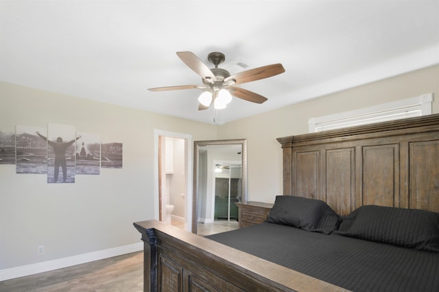 bedroom featuring ensuite bathroom, light wood finished floors, a ceiling fan, and baseboards