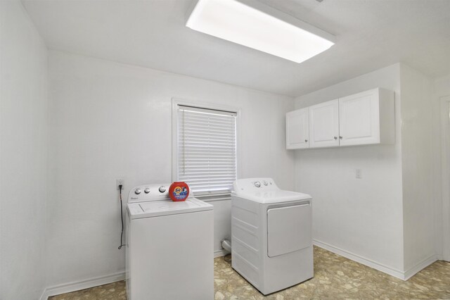 clothes washing area featuring cabinet space, baseboards, and independent washer and dryer