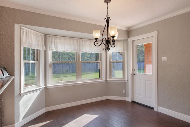 unfurnished dining area featuring dark wood-style floors, a textured wall, crown molding, and baseboards