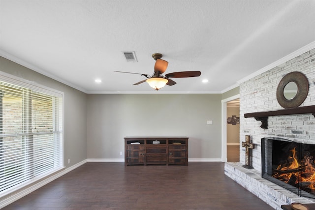 unfurnished living room featuring wood finished floors, visible vents, baseboards, ornamental molding, and a brick fireplace