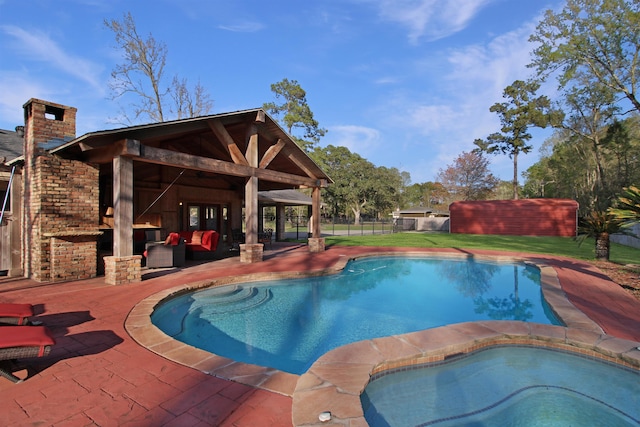 view of swimming pool featuring a patio, fence, a fenced in pool, and an in ground hot tub