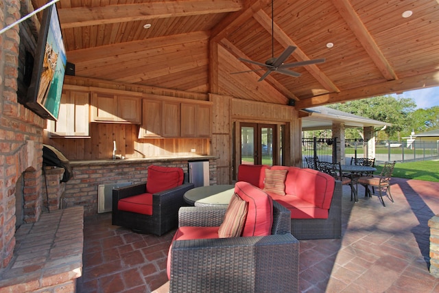 view of patio with fence, an outdoor living space, and french doors