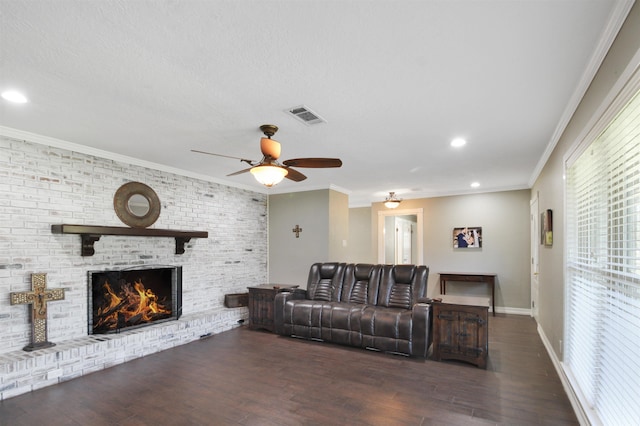 living room with ornamental molding, wood finished floors, and visible vents