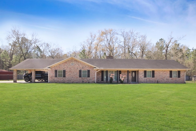 ranch-style house featuring an attached carport, a chimney, a front yard, and brick siding