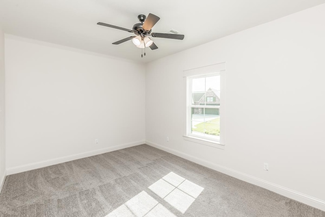 unfurnished room featuring light carpet and ceiling fan