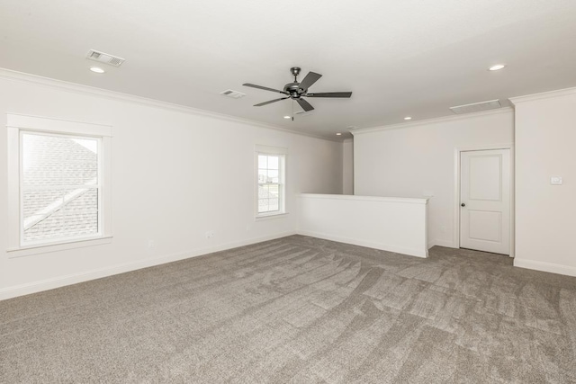 empty room with crown molding, light colored carpet, and ceiling fan