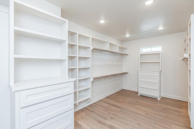 walk in closet featuring light hardwood / wood-style flooring