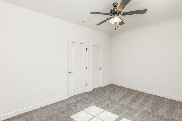 carpeted empty room with ceiling fan