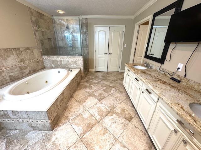 6845 Hialeah Dr, Beaumont, TX 77706 - full bathroom with a shower stall, double vanity, crown molding, a whirlpool tub, and a textured ceiling