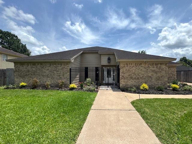 6845 Hialeah Dr, Beaumont, TX 77706 - ranch-style house featuring brick siding and a gate