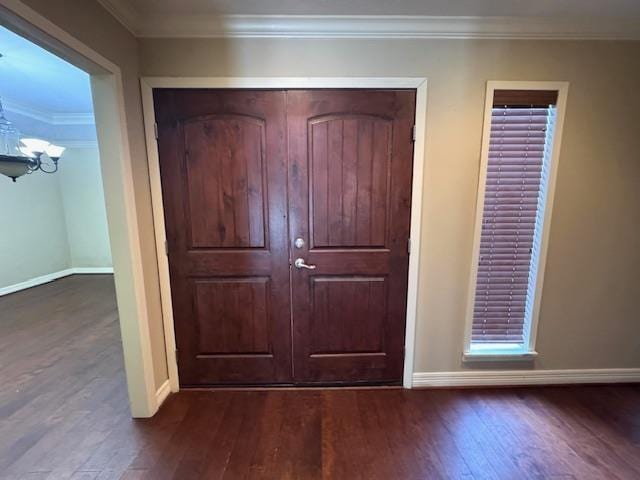 6845 Hialeah Dr, Beaumont, TX 77706 - entryway with dark wood-type flooring, baseboards, and ornamental molding