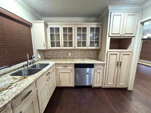 6845 Hialeah Dr, Beaumont, TX 77706 - kitchen with stainless steel dishwasher, dark wood-type flooring, a sink, decorative backsplash, and a textured ceiling