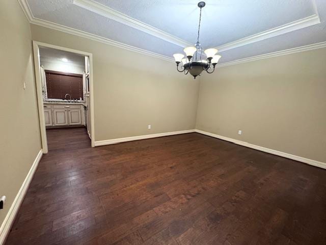 6845 Hialeah Dr, Beaumont, TX 77706 - spare room with a tray ceiling, crown molding, a chandelier, dark wood-style flooring, and baseboards