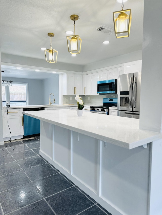 kitchen with pendant lighting, white cabinetry, appliances with stainless steel finishes, and a breakfast bar area