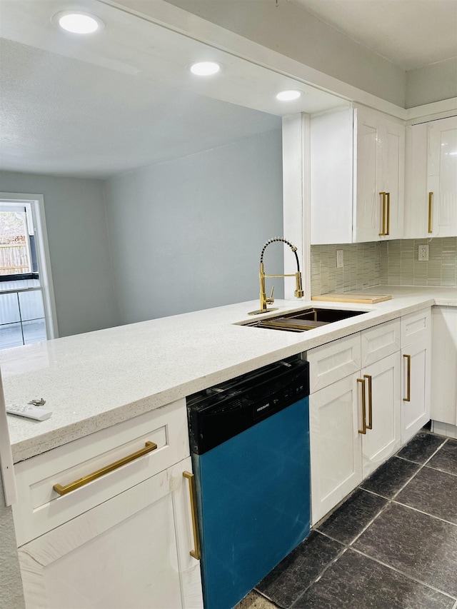 kitchen featuring tasteful backsplash, white cabinetry, dishwasher, sink, and kitchen peninsula