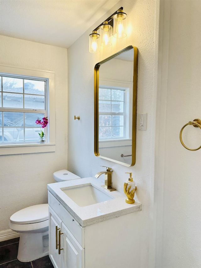 bathroom with vanity and toilet