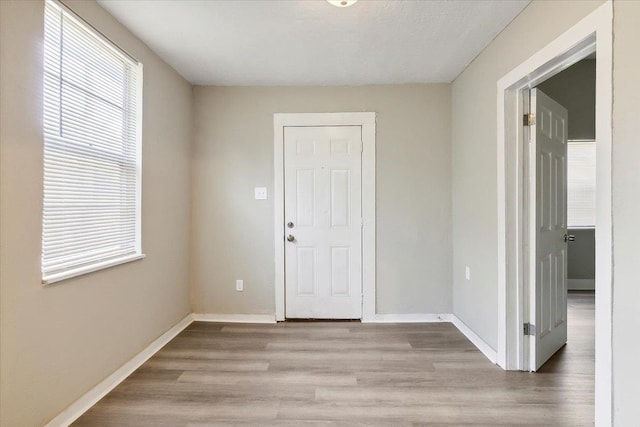 unfurnished room with light hardwood / wood-style floors