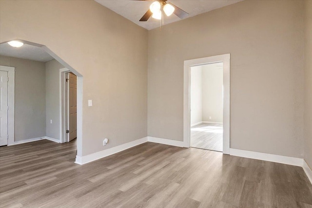 empty room with light hardwood / wood-style floors and ceiling fan