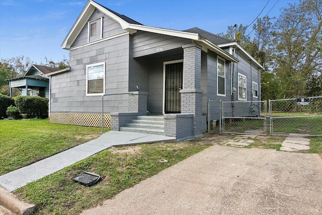 bungalow-style home with a front yard