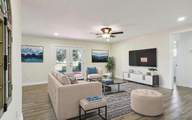 living room featuring ceiling fan, french doors, and wood-type flooring