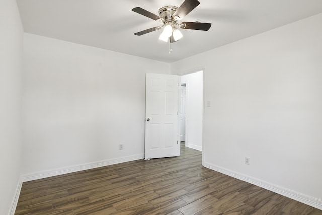 unfurnished room with ceiling fan and dark wood-type flooring