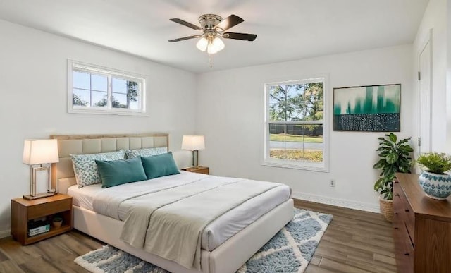 bedroom with ceiling fan and dark wood-type flooring