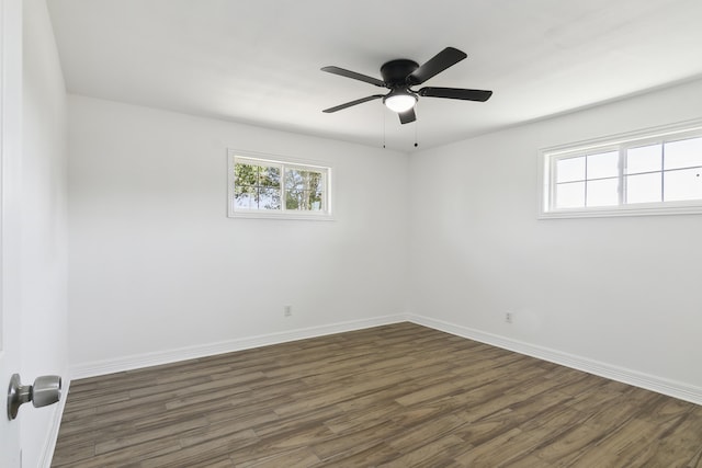 empty room featuring ceiling fan and dark hardwood / wood-style floors