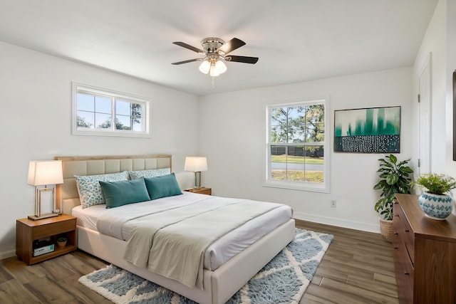 bedroom with ceiling fan and dark hardwood / wood-style floors