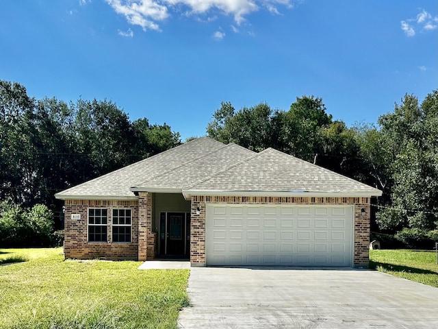 view of front of home with a front yard and a garage