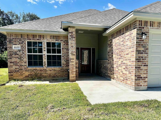 view of exterior entry with a lawn