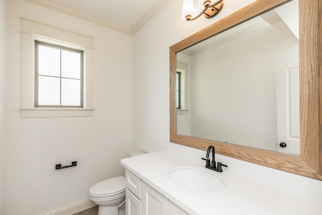 bathroom with ornamental molding, vanity, and toilet