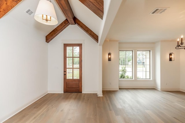 entrance foyer with an inviting chandelier, light hardwood / wood-style flooring, and vaulted ceiling with beams