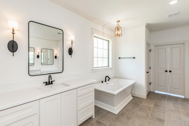 bathroom featuring a washtub, vanity, and crown molding