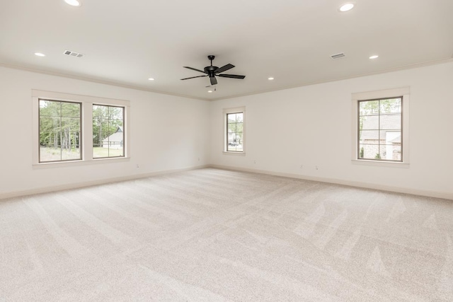 carpeted empty room featuring crown molding and ceiling fan