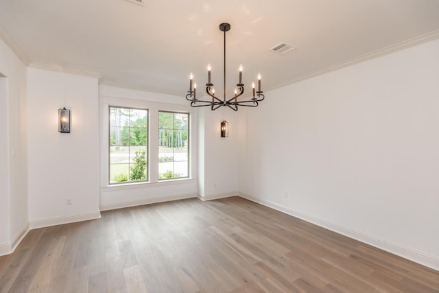 unfurnished room with ornamental molding, a chandelier, and wood-type flooring