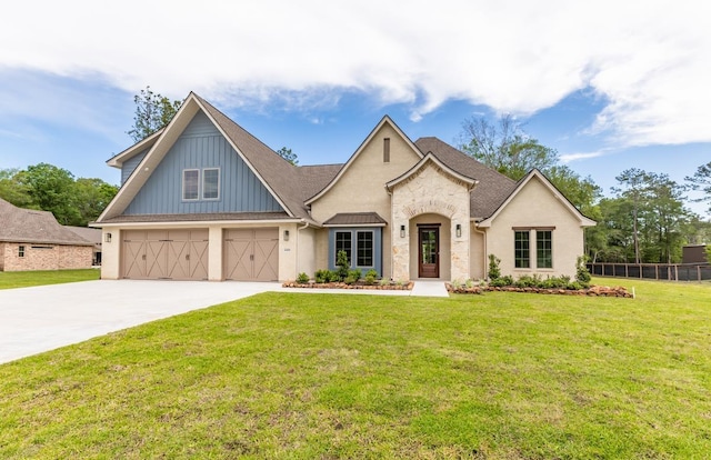 view of front of property with a garage and a front lawn