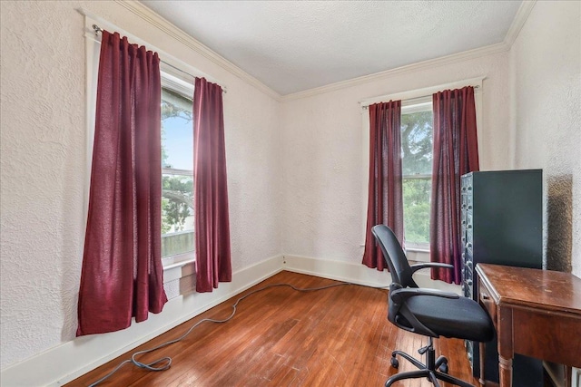 office space featuring wood-type flooring, a textured wall, ornamental molding, and baseboards