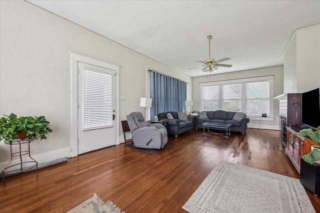 living room with a ceiling fan and wood finished floors