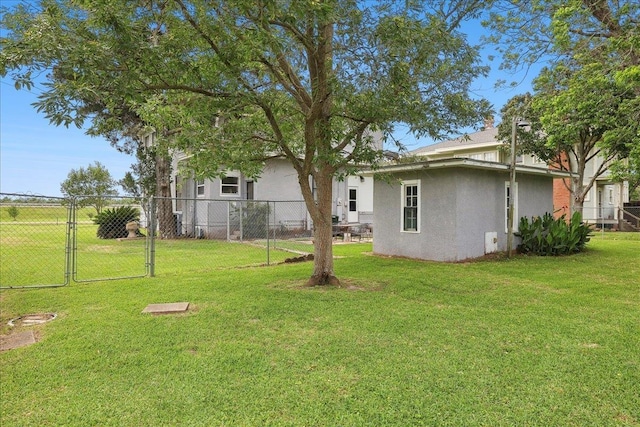 view of yard featuring fence and a gate