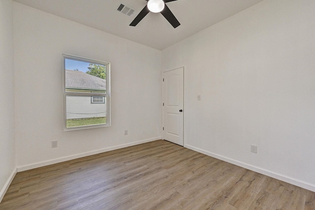 spare room featuring light hardwood / wood-style flooring and ceiling fan