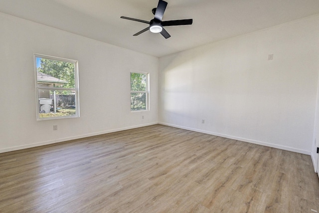 unfurnished room with light hardwood / wood-style floors, a wealth of natural light, and ceiling fan