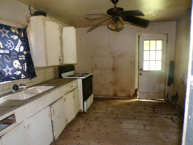 260 S 7th, Silsbee, TX 77656 - kitchen featuring electric stove, a sink, tasteful backsplash, a ceiling fan, and white cabinets