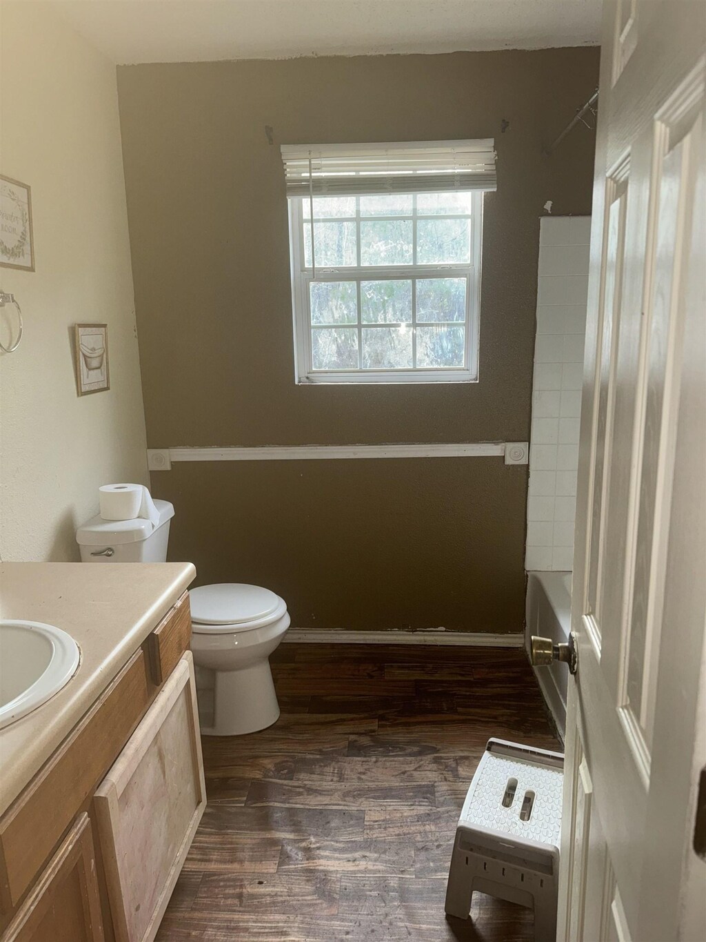 949 Martin Luther King St, Kirbyville, TX 75956 - bathroom with toilet, vanity, and wood-type flooring