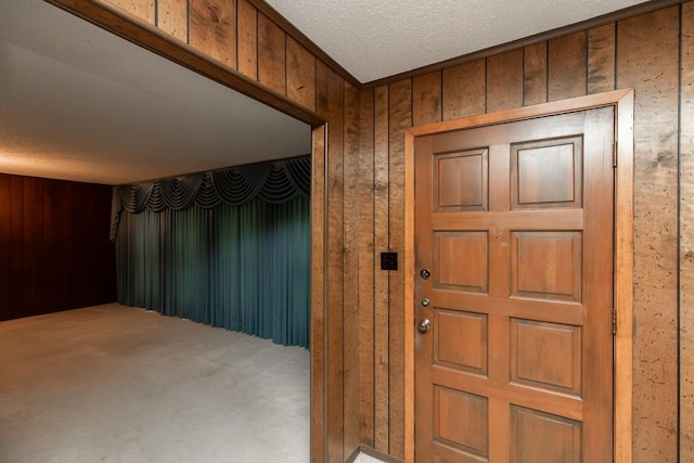 190 Magnolia Trl, Lumberton, TX 77657 - foyer entrance with carpet flooring, wood walls, and a textured ceiling