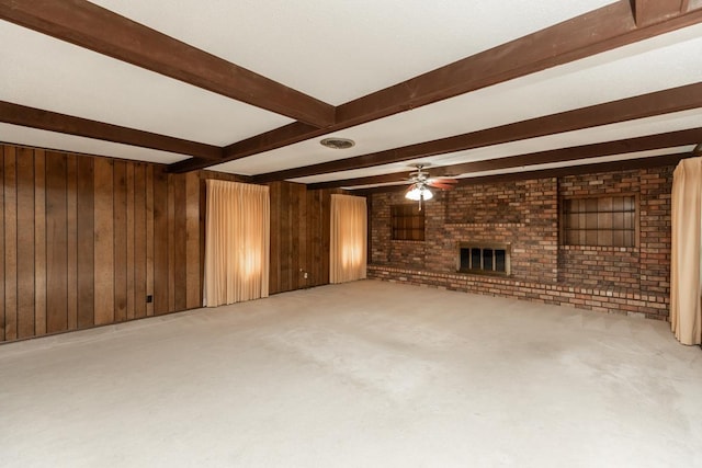 190 Magnolia Trl, Lumberton, TX 77657 - unfurnished living room with beamed ceiling, wood walls, a fireplace, a ceiling fan, and light colored carpet