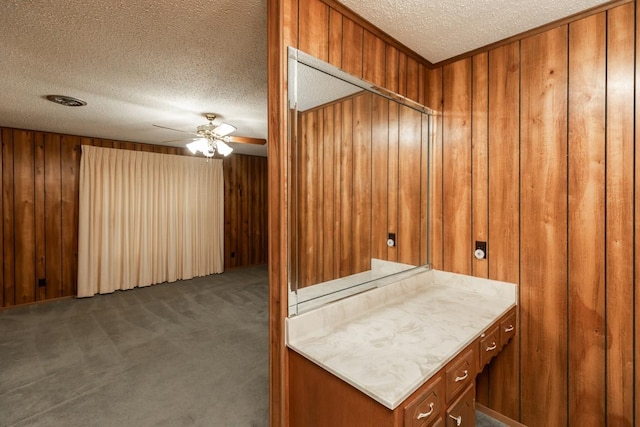190 Magnolia Trl, Lumberton, TX 77657 - washroom with a textured ceiling, dark carpet, wooden walls, and ceiling fan