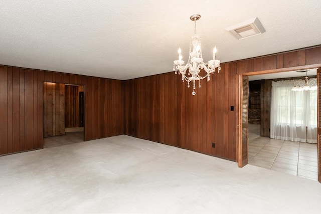 190 Magnolia Trl, Lumberton, TX 77657 - spare room with a chandelier, wood walls, and light carpet