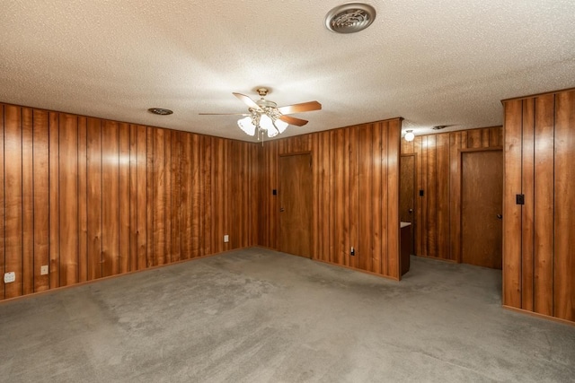 190 Magnolia Trl, Lumberton, TX 77657 - carpeted empty room featuring ceiling fan, a textured ceiling, and wood walls