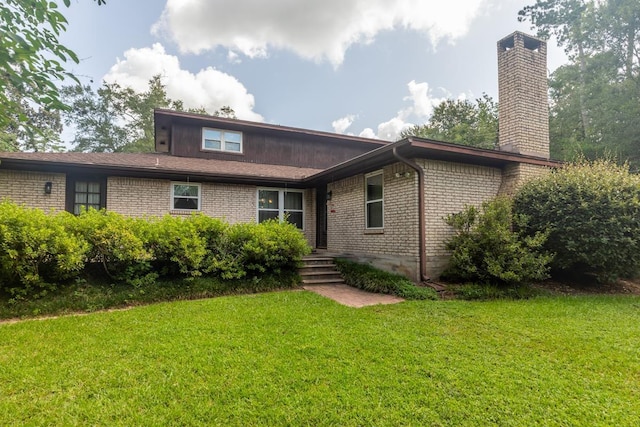190 Magnolia Trl, Lumberton, TX 77657 - back of property with brick siding, a chimney, and a lawn