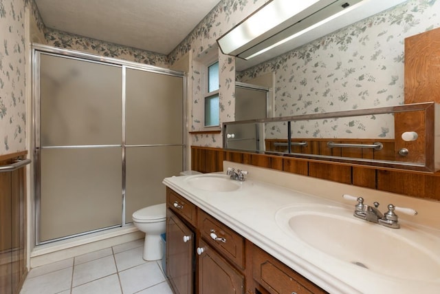 190 Magnolia Trl, Lumberton, TX 77657 - full bathroom featuring wallpapered walls, a shower stall, double vanity, and tile patterned floors
